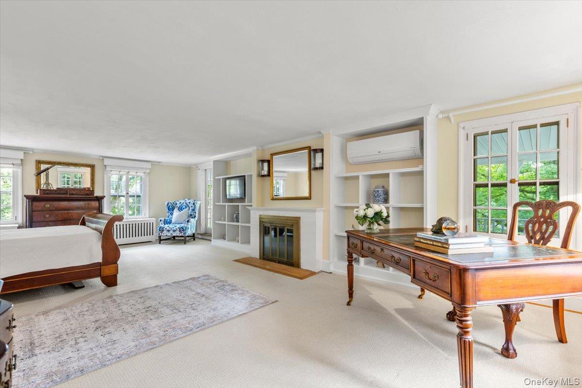 655 North Street Harrison, NY 10580 - Photo 17 of 48 a bedroom with furniture and a fireplace
