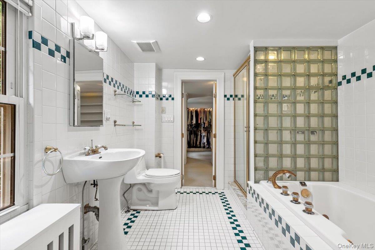 655 North Street Harrison, NY 10580 - Photo 18 of 48 a bathroom with a sink a toilet and shower