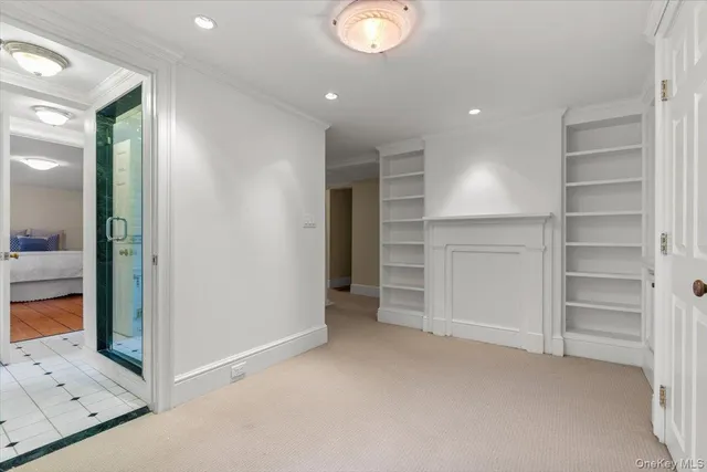 a view of an empty room and a bathroom