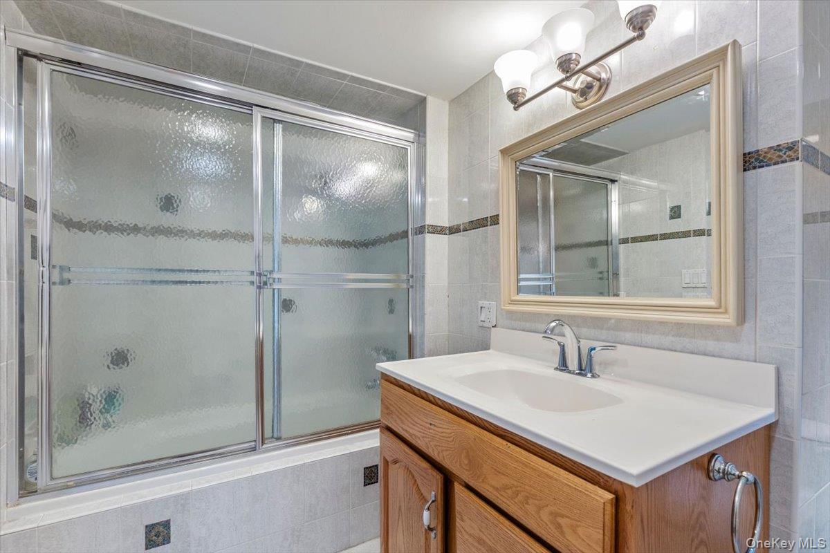 655 North Street Harrison, NY 10580 - Photo 22 of 48 a bathroom with a sink and a mirror