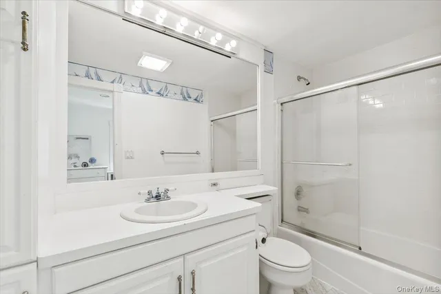 a bathroom with a sink toilet a mirror and shower