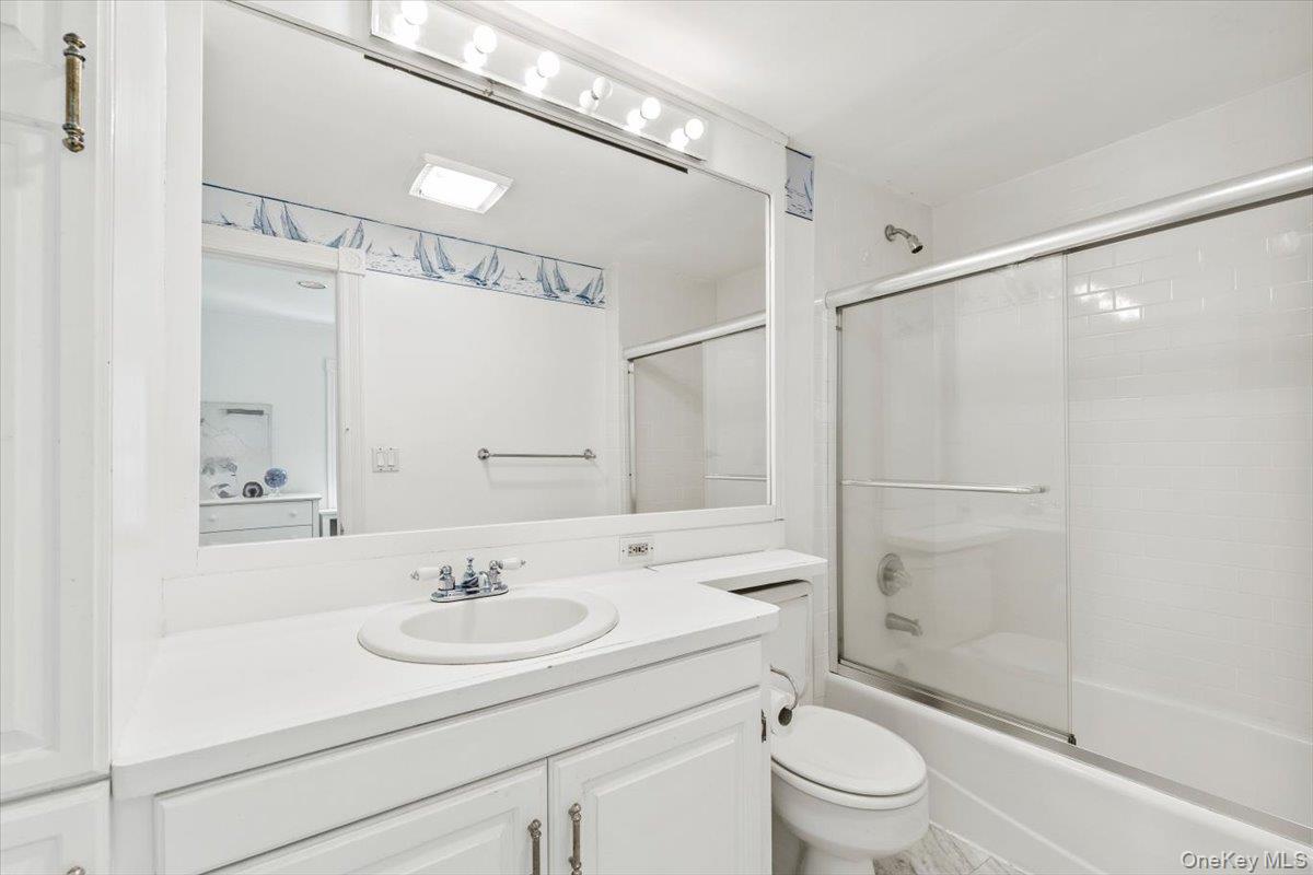 655 North Street Harrison, NY 10580 - Photo 24 of 48 a bathroom with a sink toilet a mirror and shower