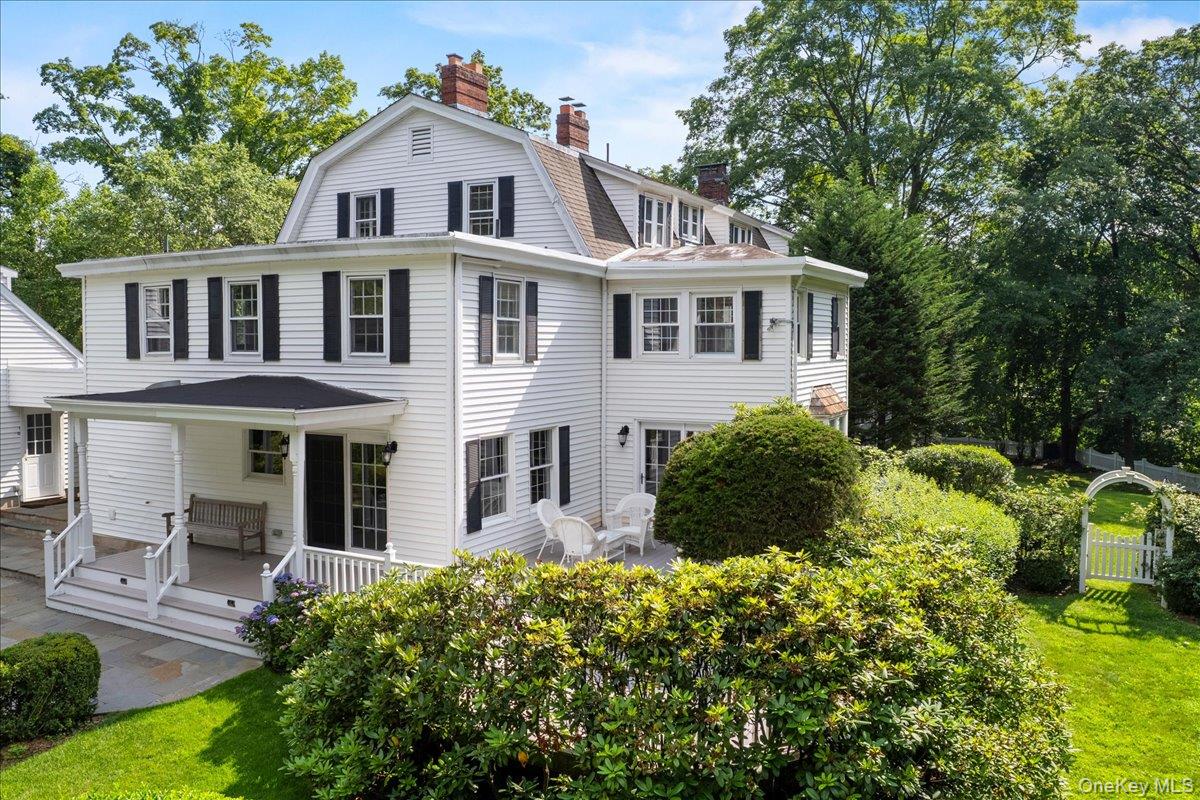 655 North Street Harrison, NY 10580 - Photo 36 of 48 a view of a white house with large windows and plants