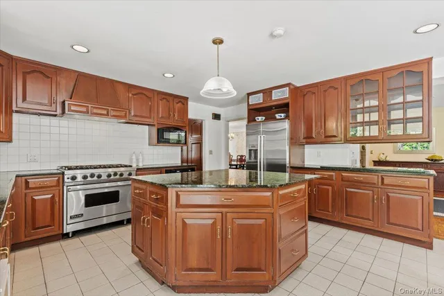 a kitchen with stainless steel appliances granite countertop a stove and cabinets