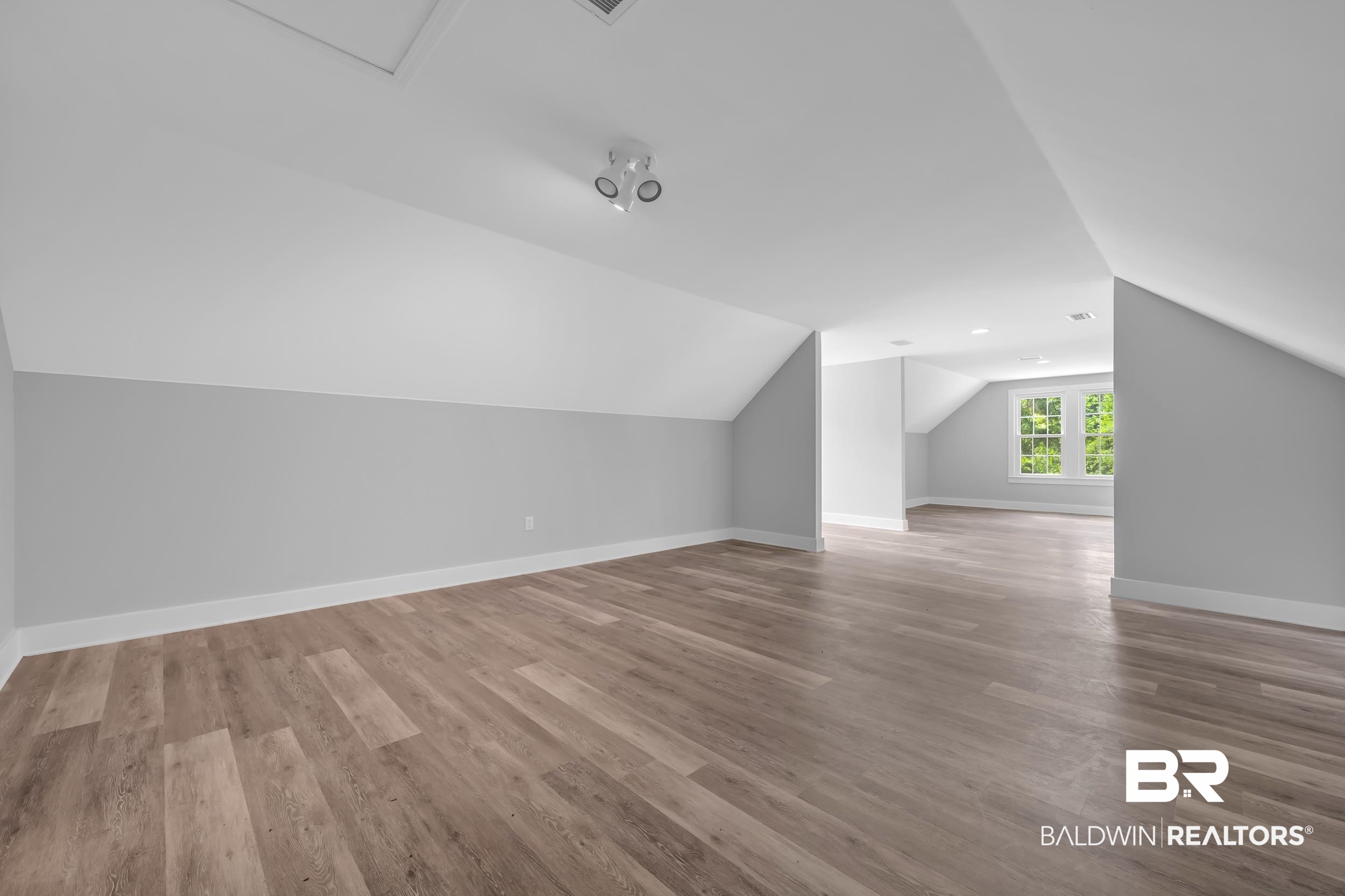 43199 Pine Grove Road Bay Minette, AL 36507 - Photo 64 of 71 Spacious room featuring wood-finish flooring, light gray walls, and white trim