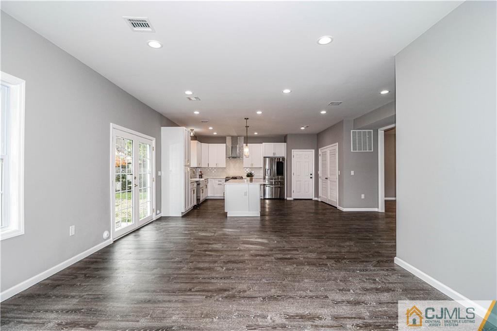 6 Dayton Road Edison, NJ 08817 - Photo 17 of 38 a view of a kitchen with kitchen island a refrigerator wooden floor and a window