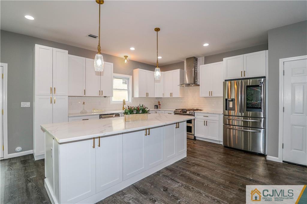 6 Dayton Road Edison, NJ 08817 - Photo 20 of 38 a kitchen with stainless steel appliances kitchen island a refrigerator sink and cabinets