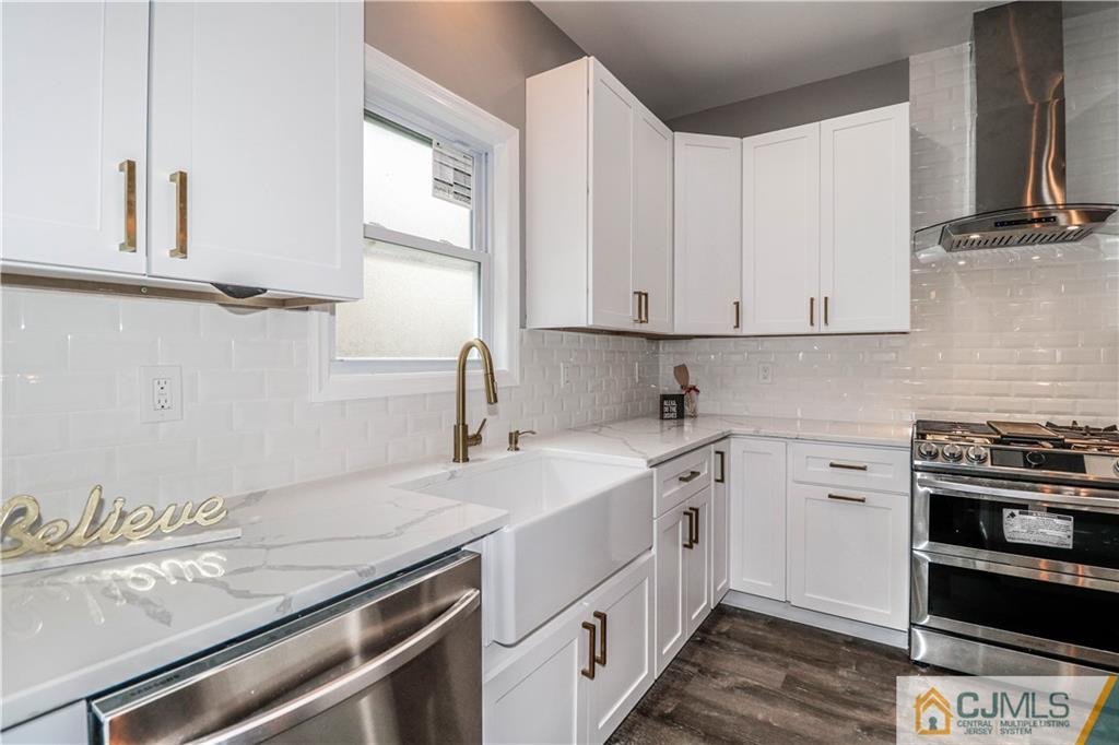 6 Dayton Road Edison, NJ 08817 - Photo 22 of 38 a kitchen with a sink stove and cabinets
