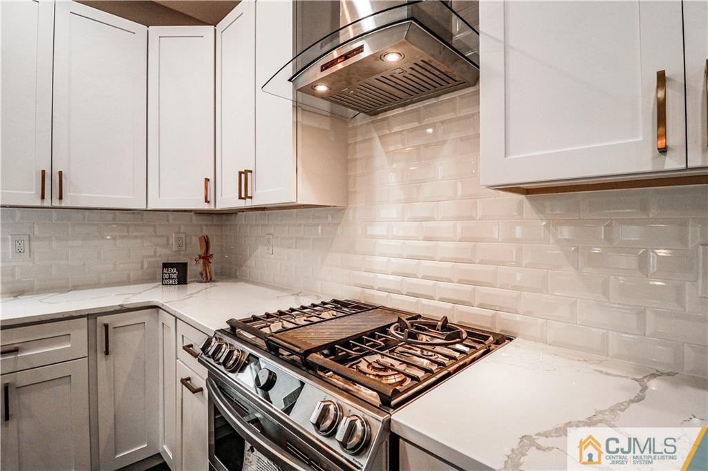6 Dayton Road Edison, NJ 08817 - Photo 23 of 38 a kitchen with a stove and a white cabinet