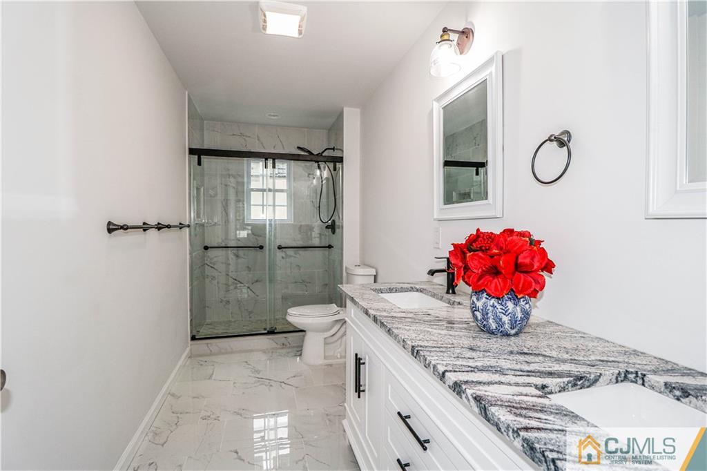 6 Dayton Road Edison, NJ 08817 - Photo 28 of 38 a bathroom with a granite countertop sink a toilet and shower