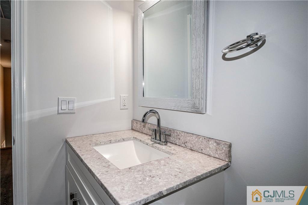 6 Dayton Road Edison, NJ 08817 - Photo 31 of 38 a bathroom with a granite countertop sink and a mirror