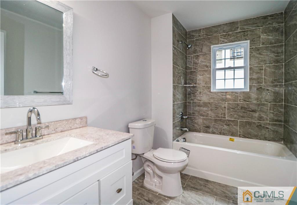 6 Dayton Road Edison, NJ 08817 - Photo 32 of 38 a bathroom with a granite countertop toilet a sink and bathtub