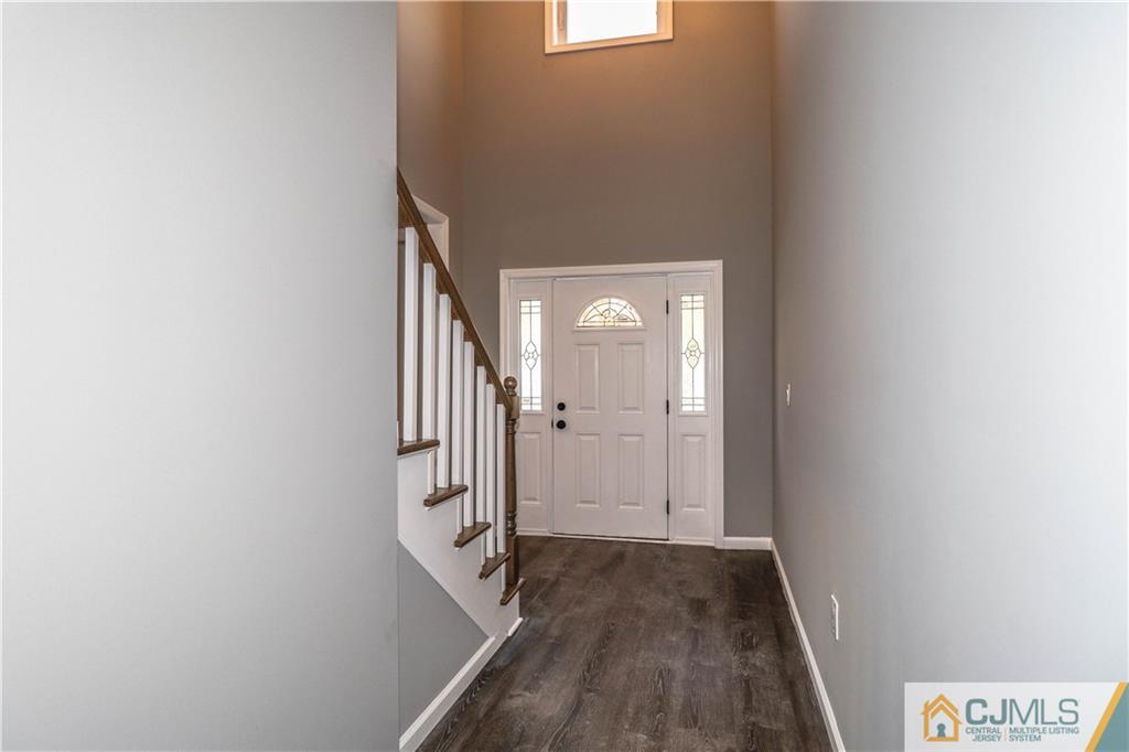 6 Dayton Road Edison, NJ 08817 - Photo 7 of 38 a view of a hallway with wooden floor and staircase