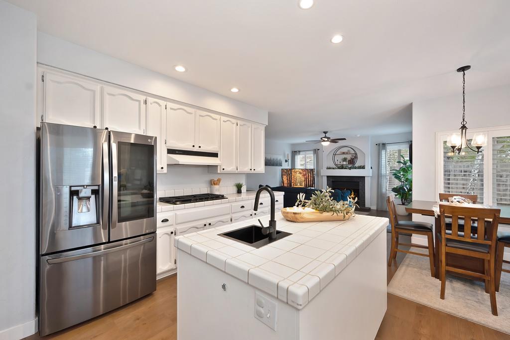 113 Ballast Way Folsom, CA 95630 - Photo 13 of 42 a kitchen with a sink a kitchen island wooden floor and stainless steel appliances