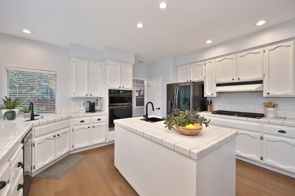 113 Ballast Way Folsom, CA 95630 - Photo 14 of 42 a kitchen with sink cabinets and refrigerator