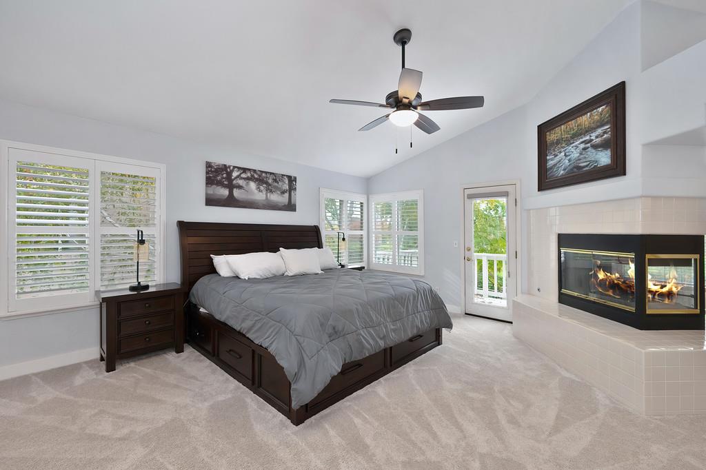 113 Ballast Way Folsom, CA 95630 - Photo 23 of 42 a spacious bedroom with a large bed a chandelier and fireplace