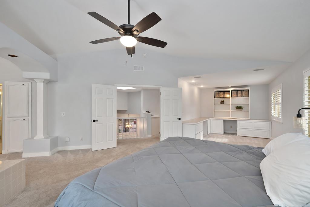 113 Ballast Way Folsom, CA 95630 - Photo 24 of 42 a spacious bedroom with a large bed and a chandelier