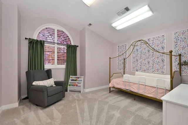 a bedroom with furniture and a window