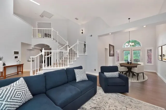 a living room with furniture fireplace and a table