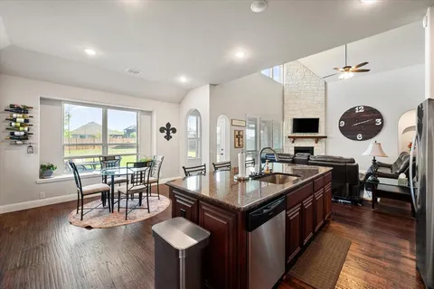 a living room with furniture a rug and a floor to ceiling window