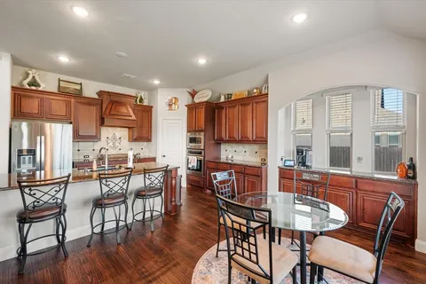 a dining room with furniture and wooden floor