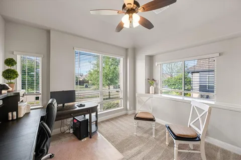 a living room with furniture and large windows
