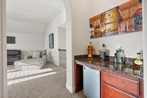a living room with furniture and a kitchen island
