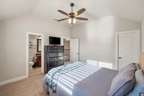 a bedroom with a bed and a television