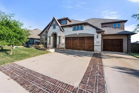 a front view of a house with yard and trees
