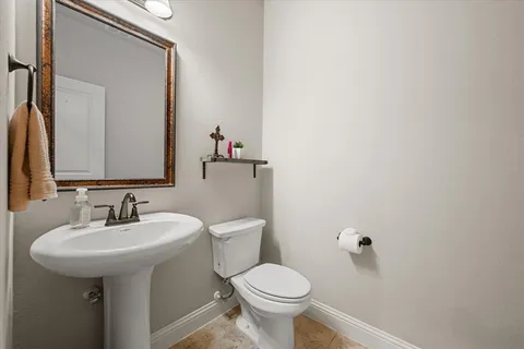 a bathroom with a sink toilet and mirror