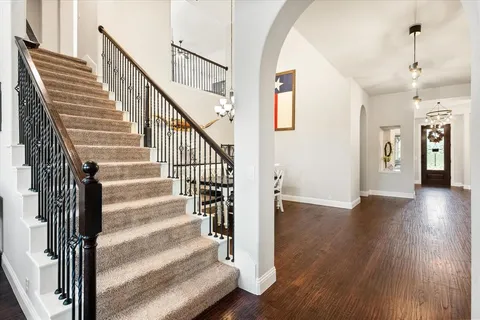 a view of staircase with white walls and a window
