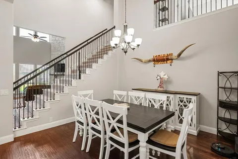 a view of a dining room with furniture wooden floor and a chandelier