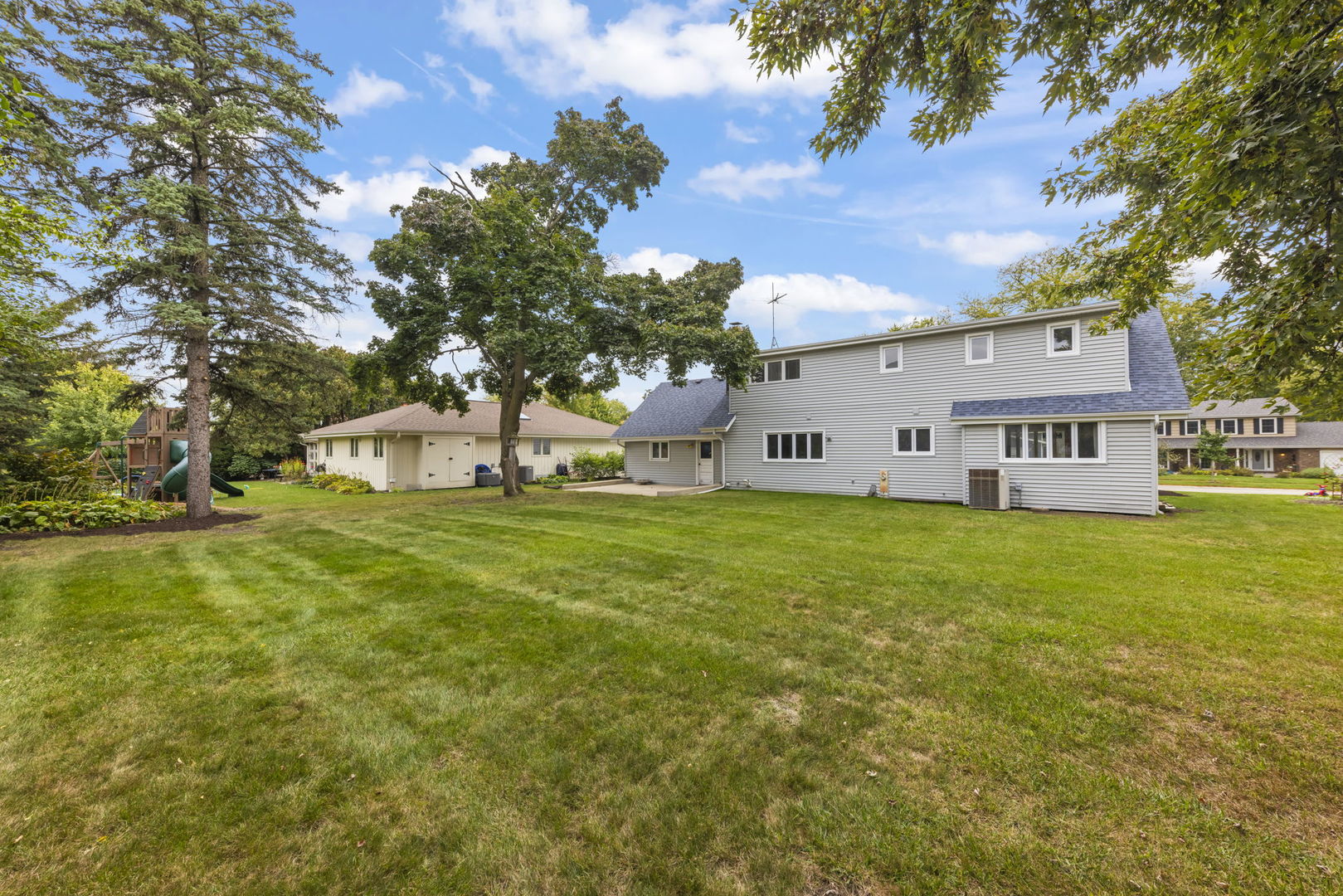 1565 North Summit Street Wheaton, IL 60187 - Photo 4 of 4 a view of a white house with a big yard and large trees