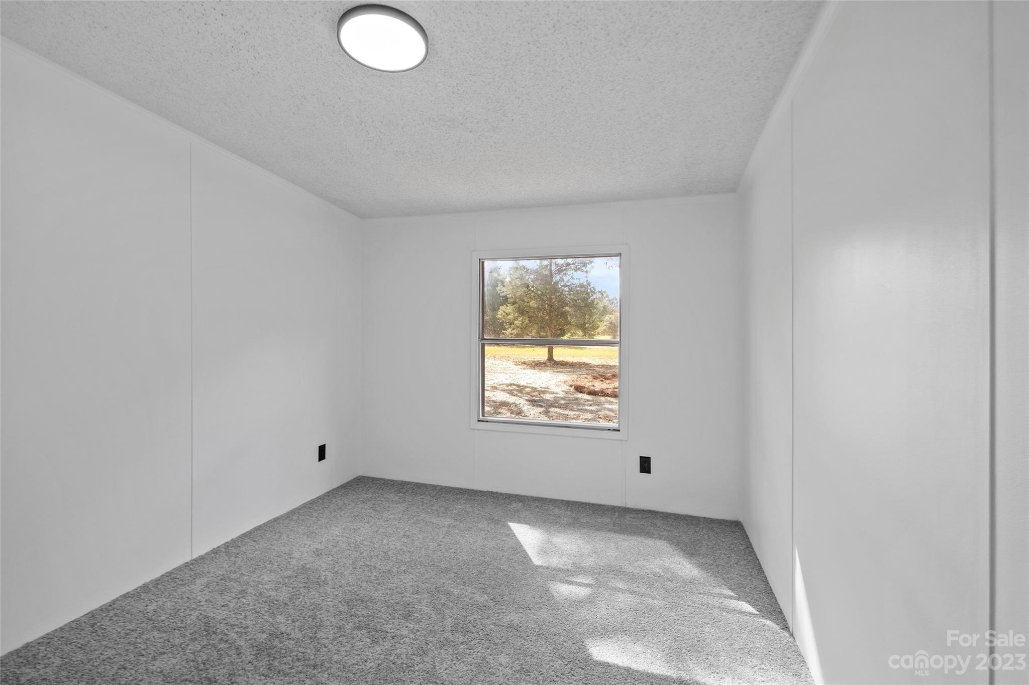 11341 Flowes Store Road Midland, NC 28107 - Photo 16 of 23 an empty room with a window