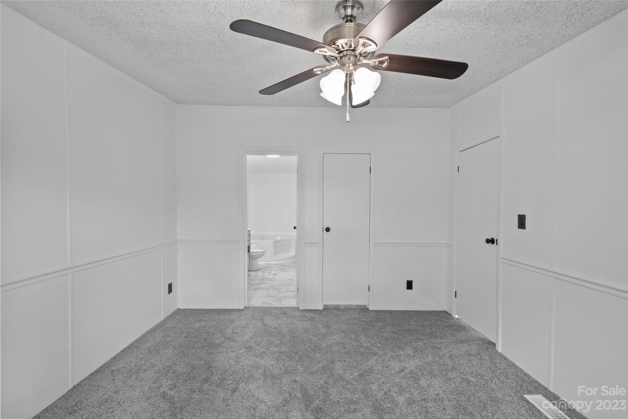 11341 Flowes Store Road Midland, NC 28107 - Photo 19 of 23 an empty room with chandelier fan
