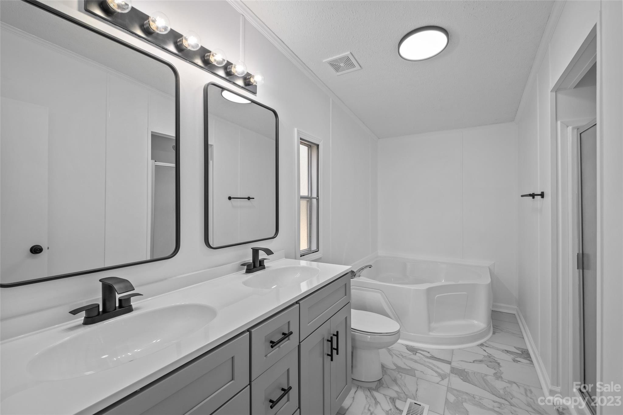 11341 Flowes Store Road Midland, NC 28107 - Photo 20 of 23 a bathroom with a granite countertop toilet sink and mirror