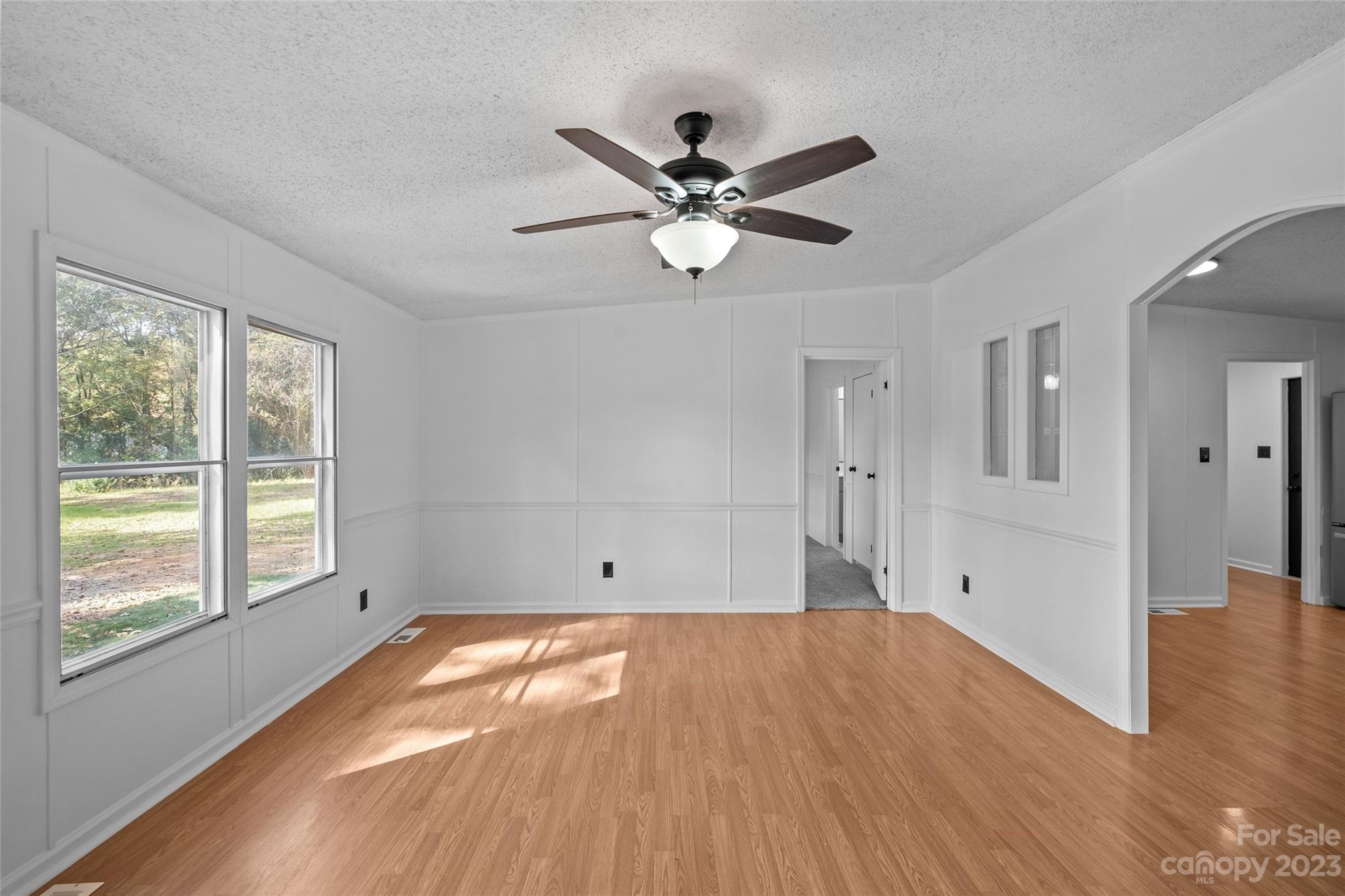 11341 Flowes Store Road Midland, NC 28107 - Photo 4 of 23 a view of empty room with wooden floor and fan