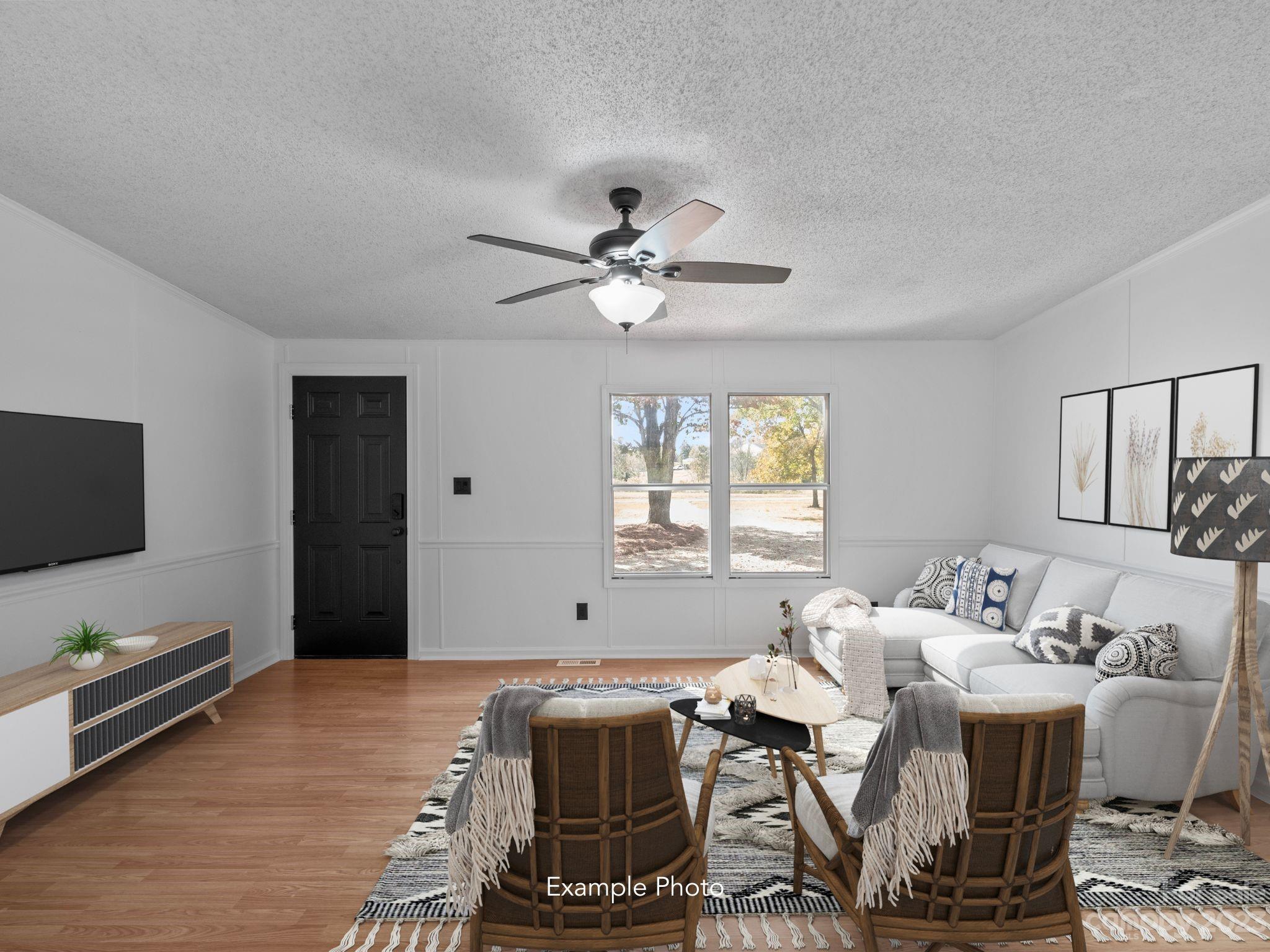 11341 Flowes Store Road Midland, NC 28107 - Photo 6 of 23 a living room with furniture a flat screen tv and a window