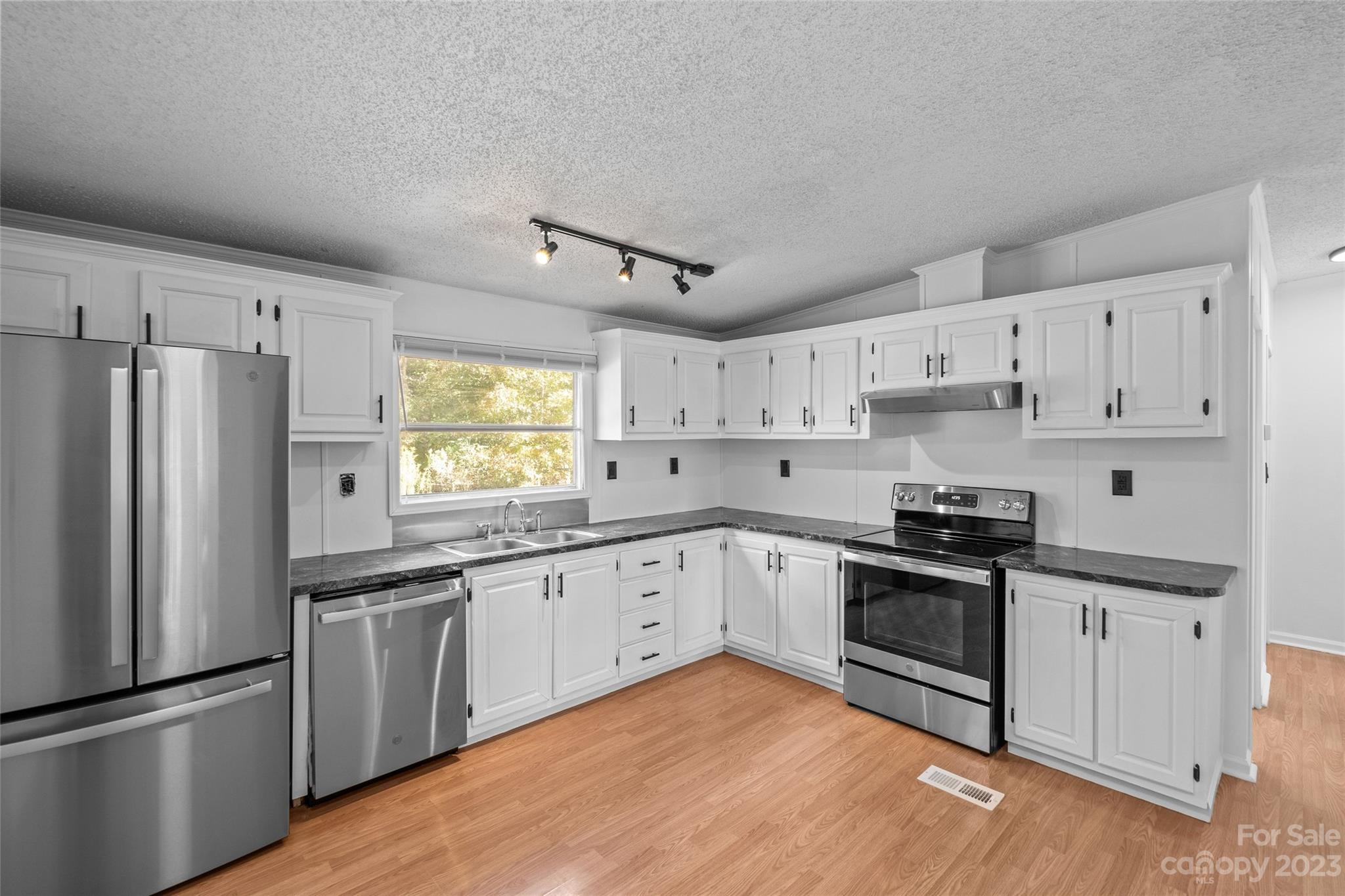 11341 Flowes Store Road Midland, NC 28107 - Photo 9 of 23 a kitchen with granite countertop a sink stainless steel appliances and window