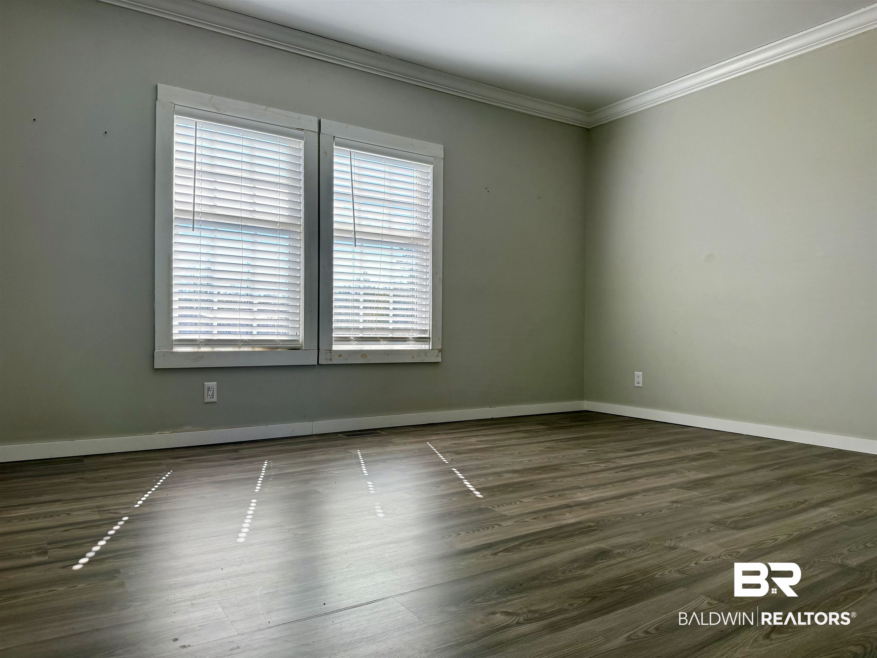 1064 Old Fannie Road Flomaton, AL 36441 - Photo 13 of 17 Unfurnished room featuring dark wood-style floors and crown molding