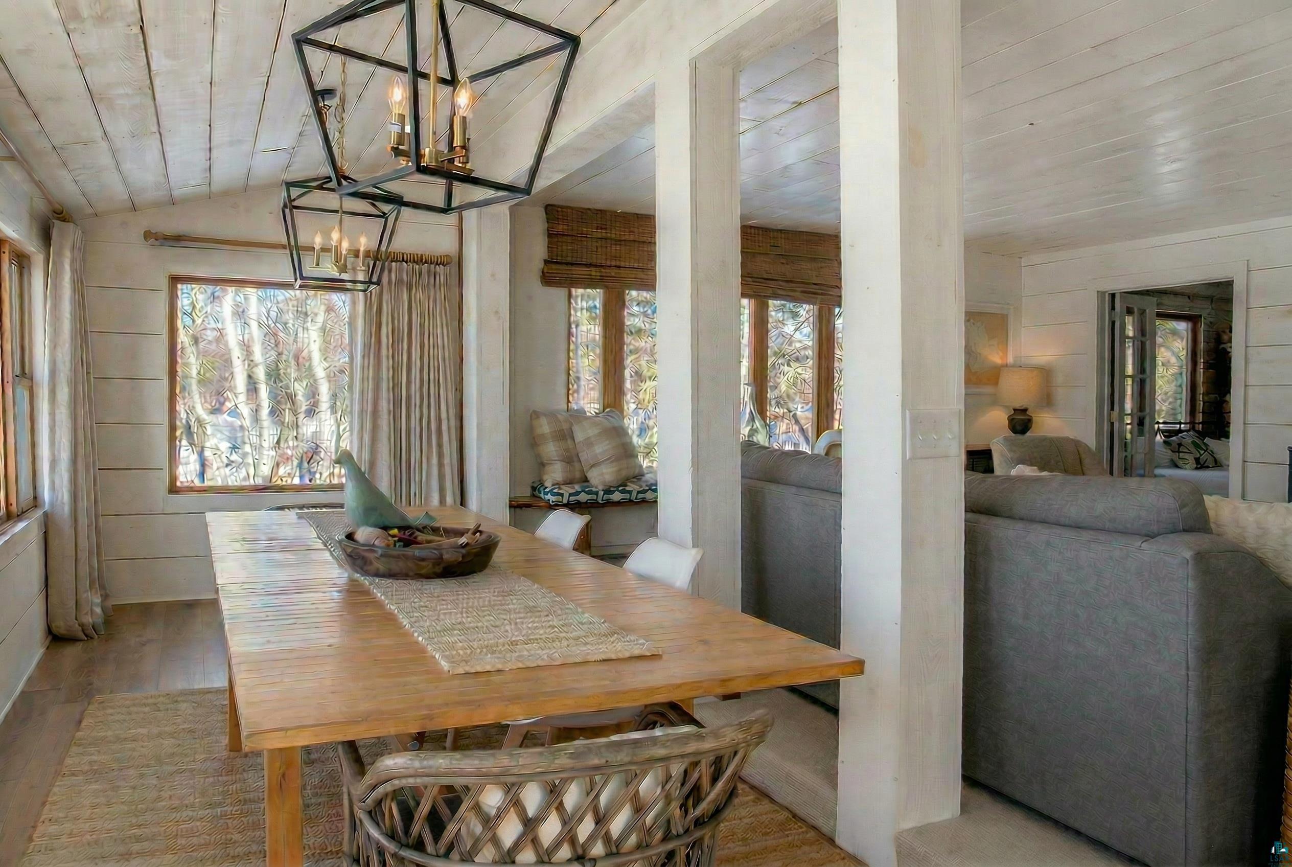4107 B Lake Park Road Ashland, WI 54806 - Photo 13 of 15 Dining room featuring a vaulted wood ceiling, wood walls, wood finished floors, and suspended lighting