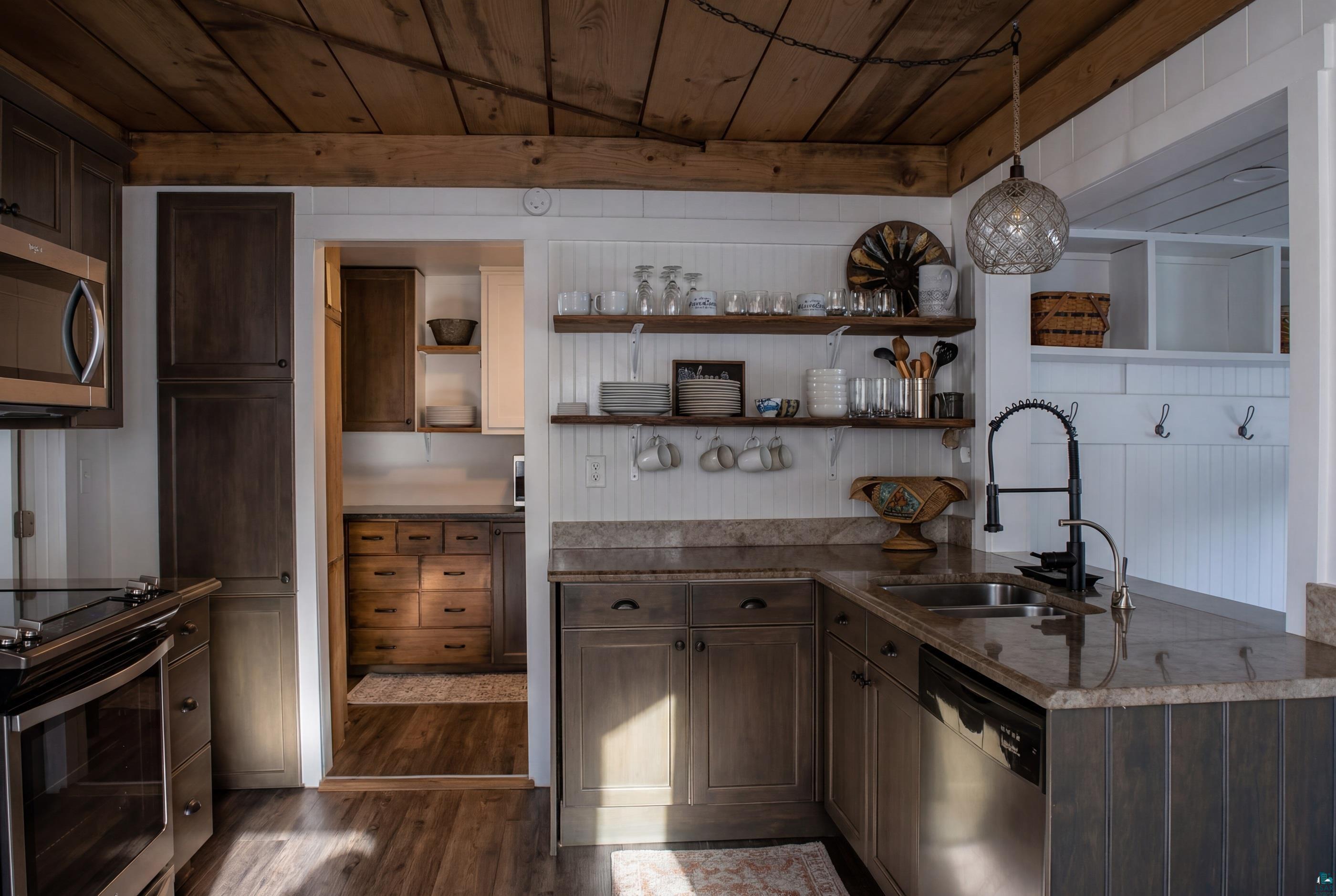 4107 B Lake Park Road Ashland, WI 54806 - Photo 8 of 15 Kitchen with open shelves, dark wood finish cabinets, wooden ceiling, and stainless steel appliances