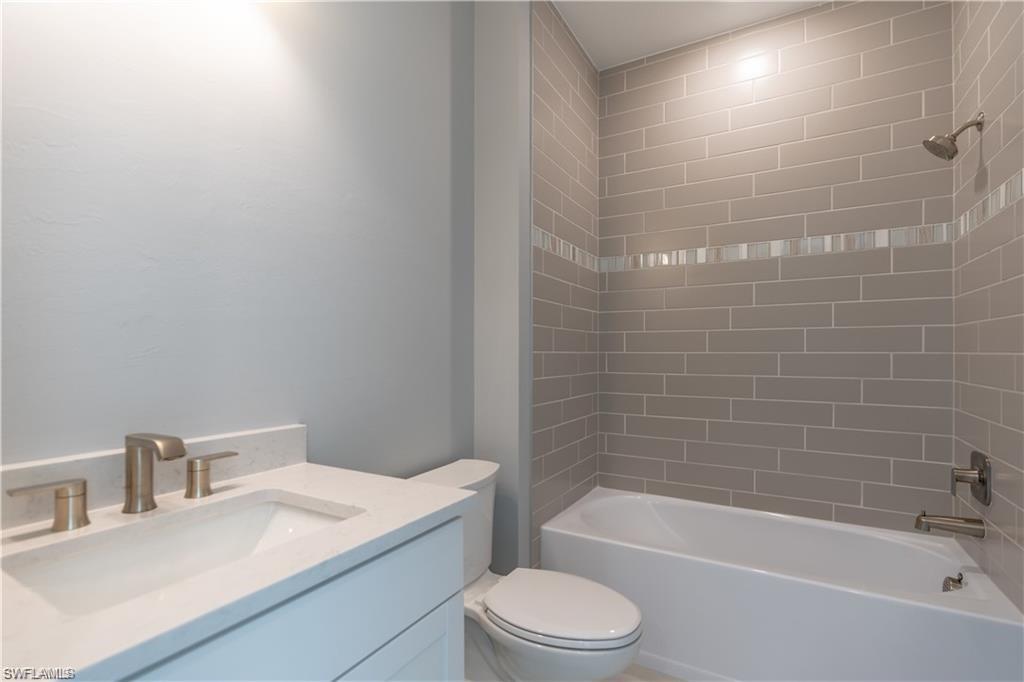 20207 Napa Loop Estero, FL 33928 - Photo 18 of 42 a bathroom with a sink a toilet and bathtub