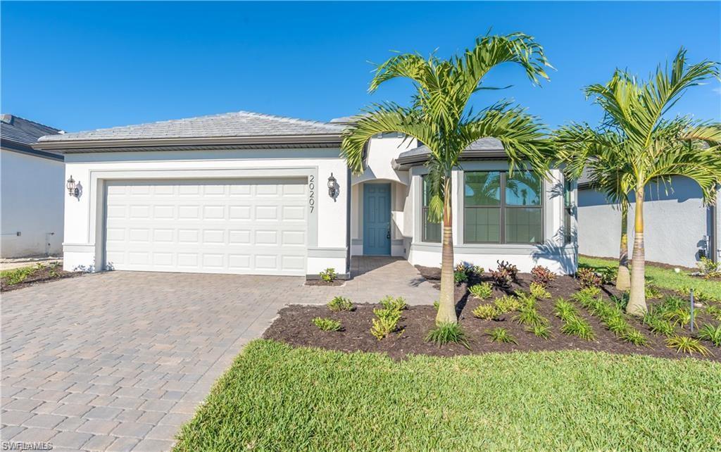 20207 Napa Loop Estero, FL 33928 - Photo 3 of 42 a view of a house with a yard and garage
