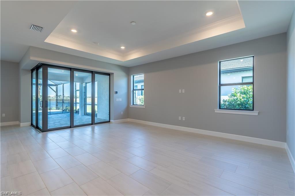20207 Napa Loop Estero, FL 33928 - Photo 6 of 42 an empty room with wooden floor and windows