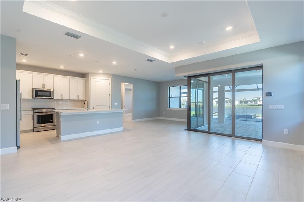 20207 Napa Loop Estero, FL 33928 - Photo 9 of 42 a large hall with a large window and stainless steel appliances