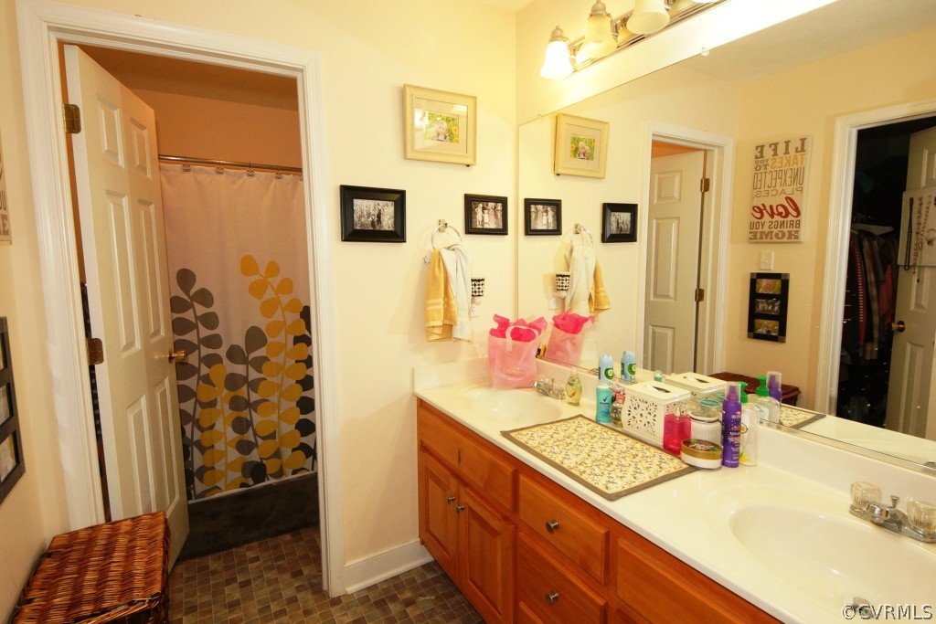 40 Winding Ridge Way Bumpass, VA 23024 - Photo 11 of 16 a bathroom with a granite countertop shower sink and mirror