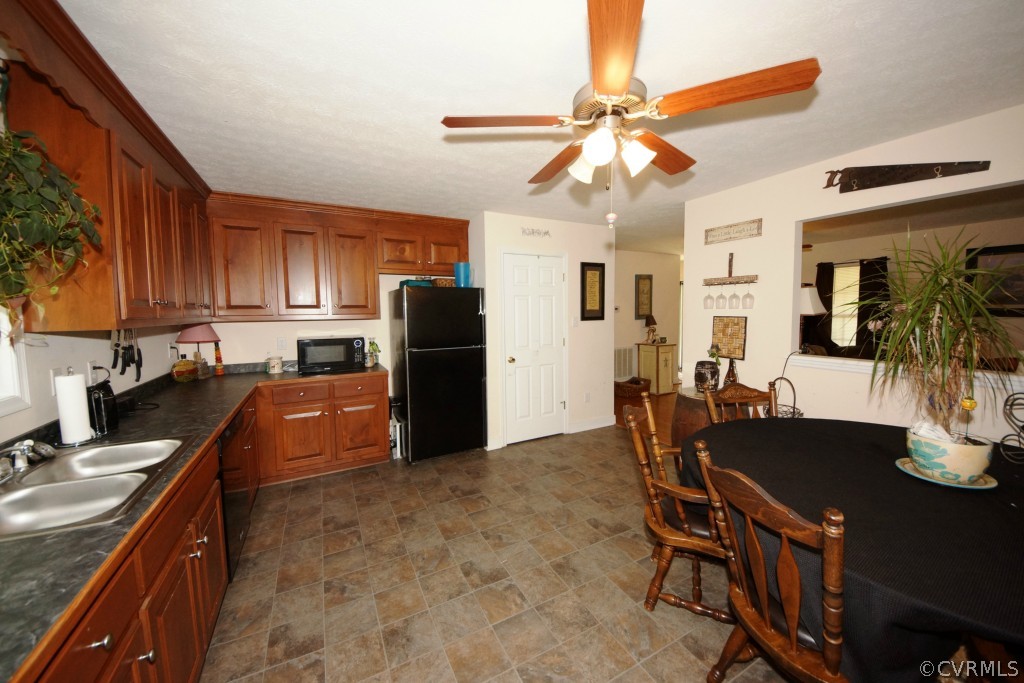 40 Winding Ridge Way Bumpass, VA 23024 - Photo 13 of 16 a kitchen with stainless steel appliances granite countertop a stove refrigerator a sink dishwasher with a dining table and chairs