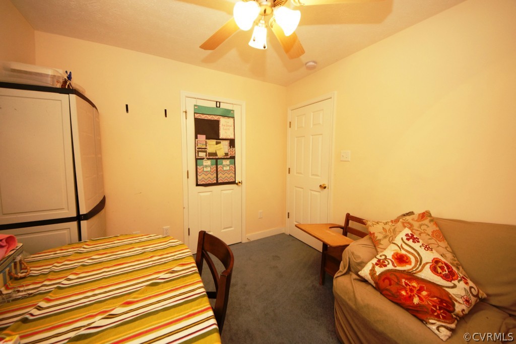 40 Winding Ridge Way Bumpass, VA 23024 - Photo 8 of 16 a bedroom with a bed and a chandelier