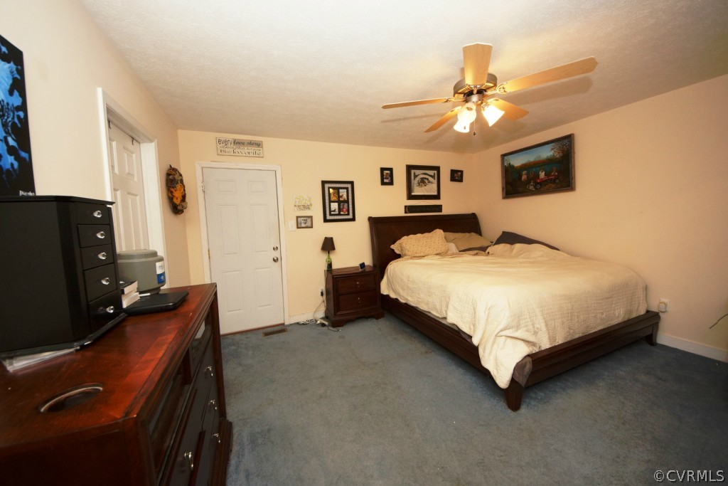 40 Winding Ridge Way Bumpass, VA 23024 - Photo 10 of 16 a spacious bedroom with a bed and a chandelier